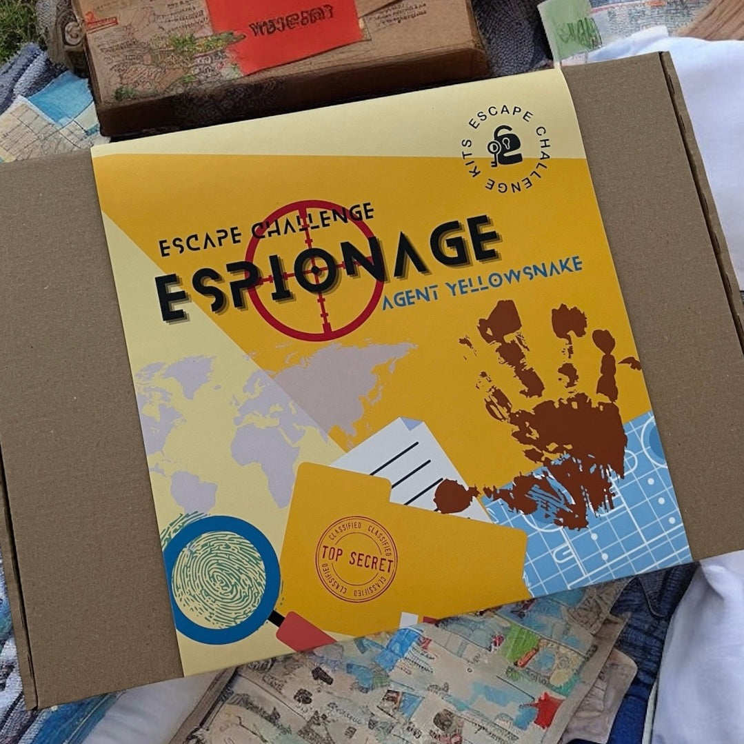 Escape room challenge kit game box titled 'Espionage' with map design on a surface with other items.